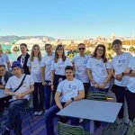 Na zdjęciu grupa ludzi. W tle widok na Malagę